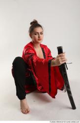 Woman Adult Average Fighting with knife Kneeling poses Coat Latino